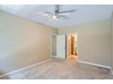 Bedroom with neutral walls, carpet, a ceiling fan and adjoining bath at 7493 S Quail Cir # 928, Littleton, CO 80127