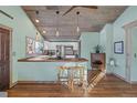 Well-lit kitchen with wooden counters and breakfast bar featuring modern stools and stainless steel appliances at 3270 Depew St, Wheat Ridge, CO 80212