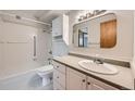 Bright bathroom featuring a vanity with drawers and a tub with shower at 655 S Alton Way # 6C, Denver, CO 80247