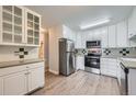 Modern kitchen with white cabinetry, stainless steel appliances, and stylish countertops at 655 S Alton Way # 6C, Denver, CO 80247
