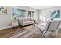 Stylish living room with large windows, wood-look floors, and modern furniture at 7649 E Amherst Ave, Denver, CO 80231