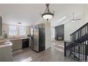 Modern eat-in kitchen featuring stainless steel appliances and an adjoining living room at 17325 E Rice Cir # F, Aurora, CO 80015