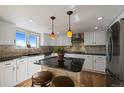 Bright kitchen featuring a center island, stainless steel appliances, and a window with a scenic view at 426 Buena Vista Rd, Golden, CO 80401
