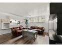 Cozy living room with hardwood floors, bright natural light, and built-in shelving at 9240 E Girard Ave # 1, Denver, CO 80231