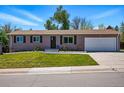 Charming single story home with a manicured lawn and an attached two-car garage at 6655 S Elm Cir, Centennial, CO 80121