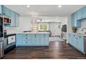 Modern kitchen features sleek stainless steel appliances and a seamless transition to the living room at 6655 S Elm Cir, Centennial, CO 80121