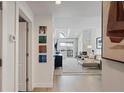 Bright hallway with light walls and a view into a living room with a fireplace at 345 Fillmore St # 407, Denver, CO 80206