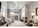 Bright living room with a marble fireplace, large windows and stylish furnishings at 345 Fillmore St # 407, Denver, CO 80206