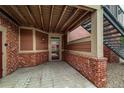 Entrance to unit #105 featuring brick accents, covered landing, and glass storm door at 804 Summer Hawk Dr # 5105, Longmont, CO 80504
