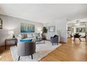 Inviting living room with wood floors, plush rug, modern furniture, and ample natural light at 1309 Alexandria St, Lafayette, CO 80026
