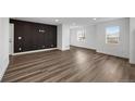 Modern living room with custom black accent wall and bright natural light at 5292 Columbine Ln, Denver, CO 80221