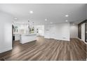Spacious living room showcasing open floor plan and hardwood floors flowing into the modern kitchen at 5292 Columbine Ln, Denver, CO 80221