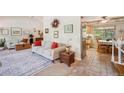 Bright living room with a couch, area rug, and view into the kitchen at 6360 S Kendall St, Littleton, CO 80123