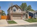 View of a two-story home with a green lawn and a driveway in a residential area at 13358 Briarwood Dr, Broomfield, CO 80020