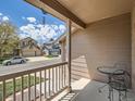 Covered porch with neutral siding, white railings, outdoor seating, and a view of the street at 13358 Briarwood Dr, Broomfield, CO 80020
