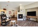 Inviting living room with a fireplace open to the dining and kitchen at 8617 Gold Peak Dr # D, Highlands Ranch, CO 80130