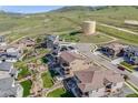 Aerial view of a neighborhood with a modern house and mountain views at 2125 S Orion St, Lakewood, CO 80228