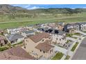 An aerial shot showcases a modern home within a community with mountain views at 2125 S Orion St, Lakewood, CO 80228