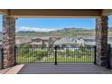 View of the neighborhood and mountains from the back porch of this home at 2125 S Orion St, Lakewood, CO 80228
