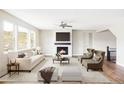 Bright living room features a fireplace, neutral decor, and large windows with views of the community at 2125 S Orion St, Lakewood, CO 80228