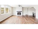 Spacious living room with hardwood floors, a fireplace, large windows, and plenty of natural light at 2125 S Orion St, Lakewood, CO 80228