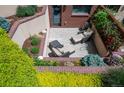 Charming outdoor patio with lounge chairs and lush landscaping surround at 402 Garfield St, Denver, CO 80206