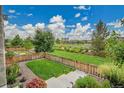 A beautiful backyard with manicured lawn, tasteful landscaping, and a charming wooden fence, perfect for relaxing outdoors at 21345 E 59Th Dr, Aurora, CO 80019