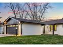 Charming single-story home with an attached garage and a well-kept lawn at 6142 Dudley Ct, Arvada, CO 80004