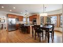 A spacious kitchen featuring wood cabinets, stainless steel appliances, granite countertops and an eat-in kitchen space at 3891 Windchant Cir, Castle Rock, CO 80104