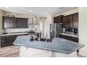 Modern kitchen features a large island, stainless steel appliances, and designer backsplash at 6147 N Flanders St, Aurora, CO 80019