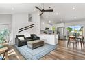 Open-concept living space with a vaulted ceiling, and modern furnishings at 6604 S Dahlia Cir, Centennial, CO 80121
