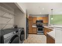 Efficient kitchen with stainless steel appliances, ample cabinets, and tile flooring at 2002 E 102Nd Cir, Thornton, CO 80229