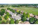 Picturesque aerial shot showcasing the neighborhood's lush greenery and well-spaced homes at 1153 Village Cir, Erie, CO 80516