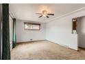 Inviting living room featuring neutral carpet, a ceiling fan, and natural light from a window at 6930 Warren Dr, Denver, CO 80221