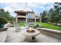 Backyard boasts tiered landscaping, a stone fire pit, and a covered patio, perfect for outdoor entertaining at 8337 Greenwood Dr, Niwot, CO 80503