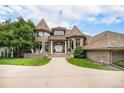 Elegant brick home features a turret-style design, manicured lawn, and a welcoming entrance, creating a grand curb appeal at 8337 Greenwood Dr, Niwot, CO 80503