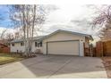 House exterior showcasing a two-car garage and yard at 3460 W 131St Ave, Broomfield, CO 80020