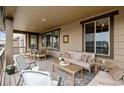 Relaxing deck with seating area, wooden furniture, and view at 8107 Arapahoe Peak St, Littleton, CO 80125