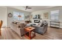 Bright living room featuring hardwood floors, neutral decor, and a cozy fireplace at 5741 Echo Park Cir, Castle Rock, CO 80104