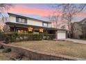 Inviting two-story home showcasing classic architecture, mature trees, and a manicured front yard at 1998 S Harlan Ct, Lakewood, CO 80227