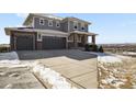 Beautiful two-story home featuring a three-car garage and meticulously maintained landscaping at 20132 Spruce Point Pl, Parker, CO 80134