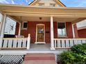 Inviting front porch with classic brick exterior and a charming porch swing at 52 S Washington St, Denver, CO 80209