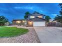 Charming two-story home boasts a well-maintained lawn, brick accents, and an attached two-car garage at 15918 E Flora Pl, Aurora, CO 80013