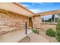 Charming front entrance with brick facade, manicured landscaping, and a pathway at 2180 S Flower Way, Lakewood, CO 80227