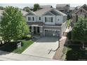 Aerial view of a two-story home with well-manicured front and back lawns in a suburban neighborhood at 2198 Broadleaf Loop, Castle Rock, CO 80109