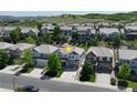 Aerial view of a gray two-story home with a basketball hoop in a suburban neighborhood at 2198 Broadleaf Loop, Castle Rock, CO 80109