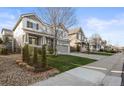 Street view showcases manicured lawns and the charming exteriors of homes with two-car garages at 2198 Broadleaf Loop, Castle Rock, CO 80109