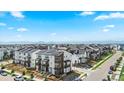 A neighborhood featuring modern townhomes with solar panels and mountain views at 16637 Shoshone St, Broomfield, CO 80023