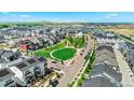 A neighborhood featuring modern townhomes with a green park area and scenic views at 16637 Shoshone St, Broomfield, CO 80023