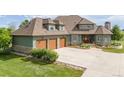 Beautiful home featuring a three-car garage, stone accents, mature bushes, and a well-manicured lawn at 2370 W 152Nd Ave, Broomfield, CO 80023